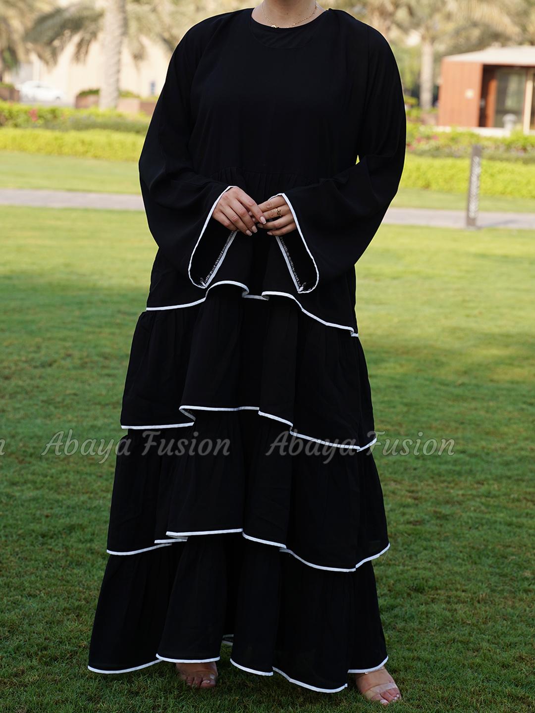 Abaya black with frill work in white Piping